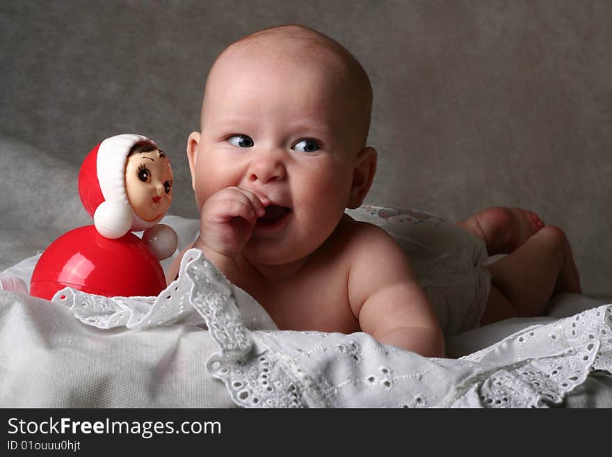 Cheerful 5 months old  baby girl with  toy. Cheerful 5 months old  baby girl with  toy