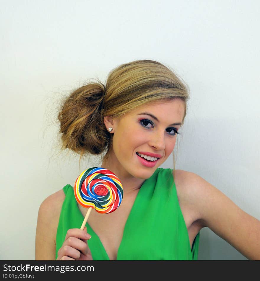 Pretty young woman in candy shop with green dress. Pretty young woman in candy shop with green dress