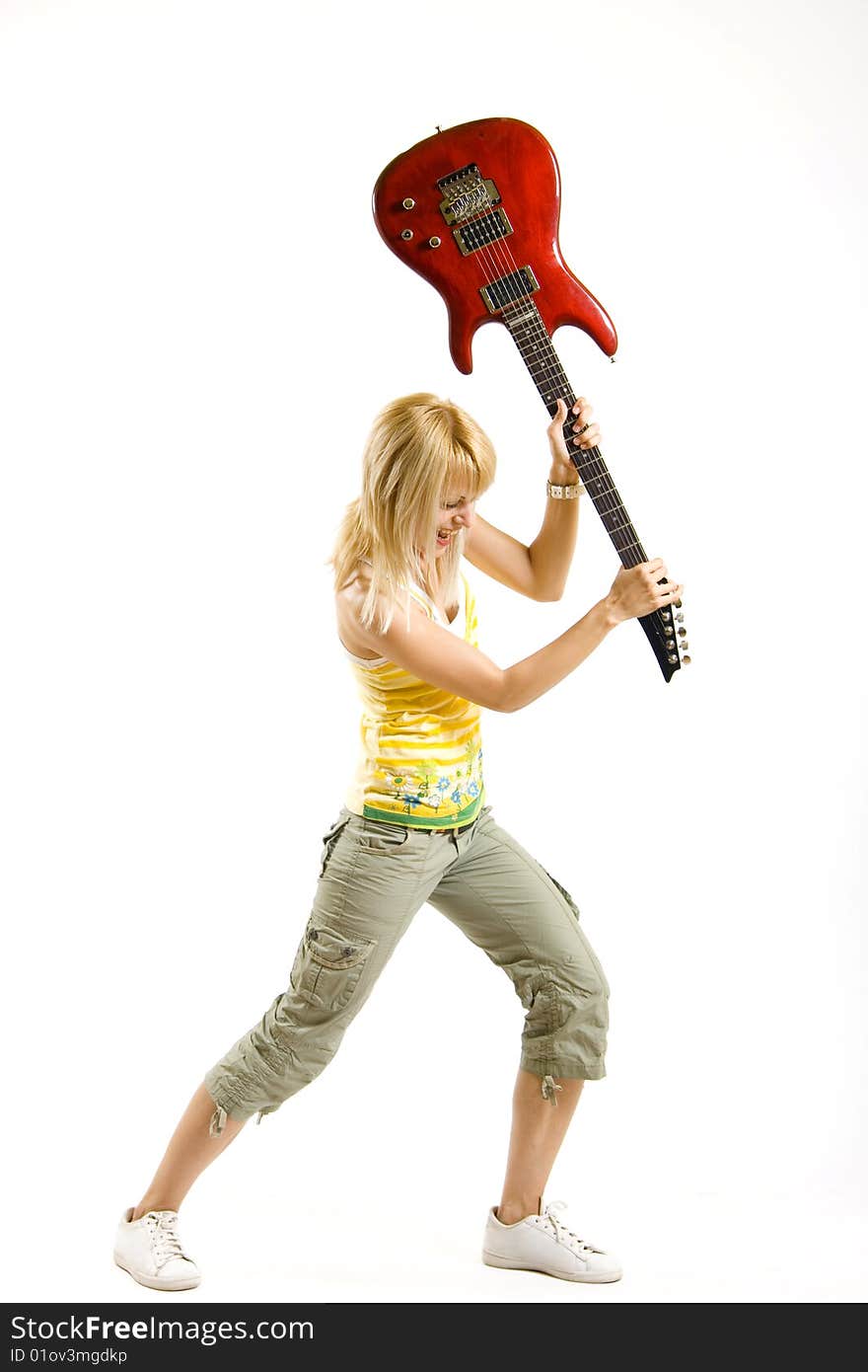 Woman guitarist breaking her guitar on white background