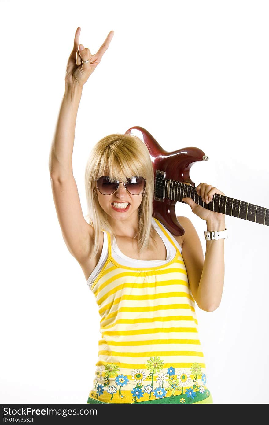 Portrait of an attractive woman guitarist making a rock sign