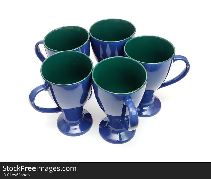 Circle of five blue long-stemmed coffee cups with handles out isolated. Circle of five blue long-stemmed coffee cups with handles out isolated