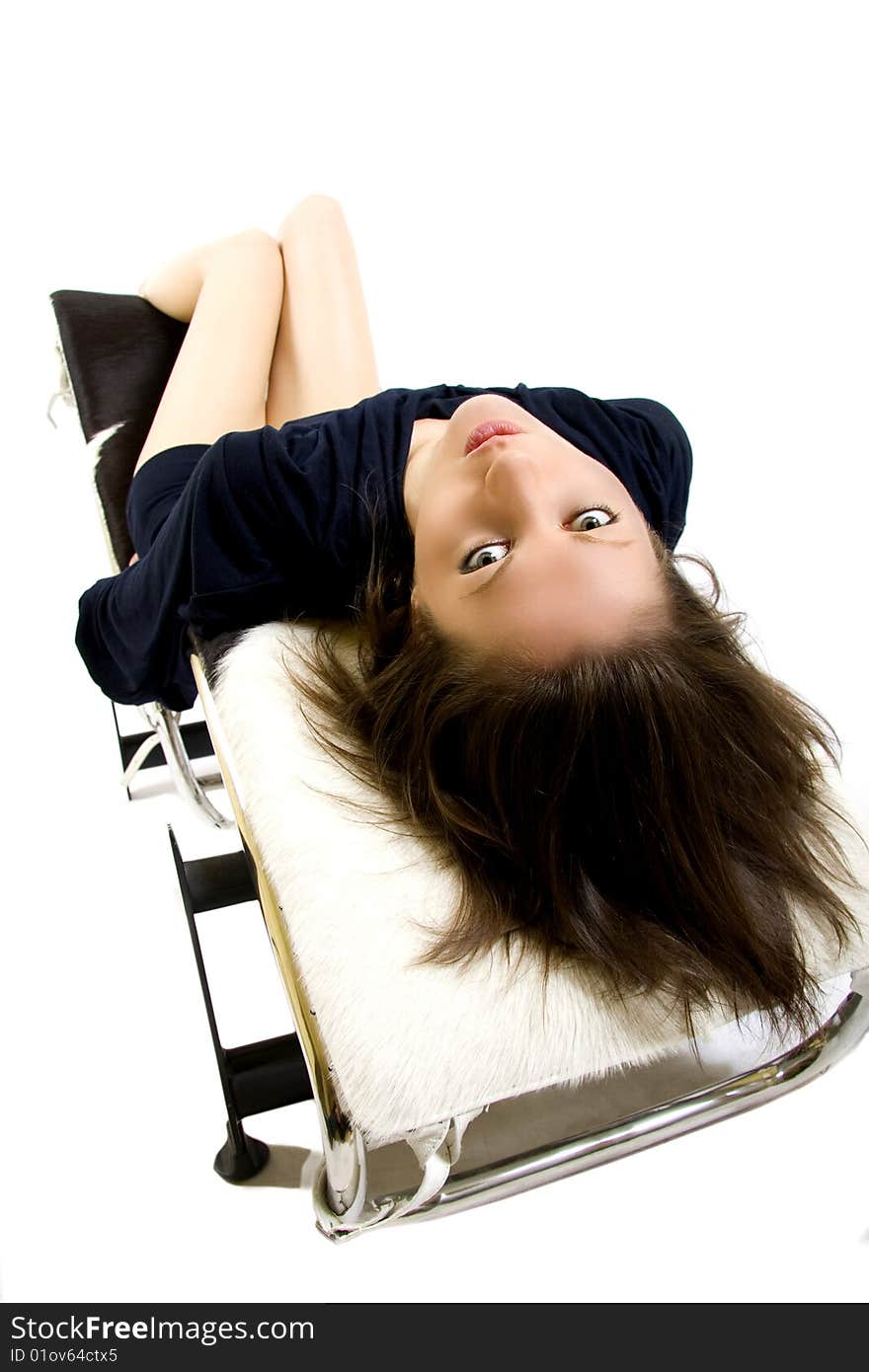 Attractive woman standing on a long chair. Attractive woman standing on a long chair