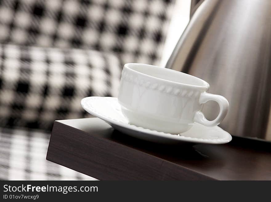 Ceramic white cup and a saucer on the table. Ceramic white cup and a saucer on the table