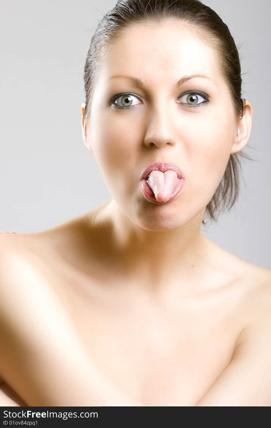 Closeup of a beautiful woman's face - tongue out. Closeup of a beautiful woman's face - tongue out