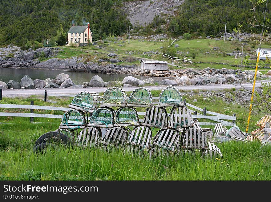 A typical fishing scene in rural Newfoundland with lobster traps lying idle waiting for a new season. A typical fishing scene in rural Newfoundland with lobster traps lying idle waiting for a new season.