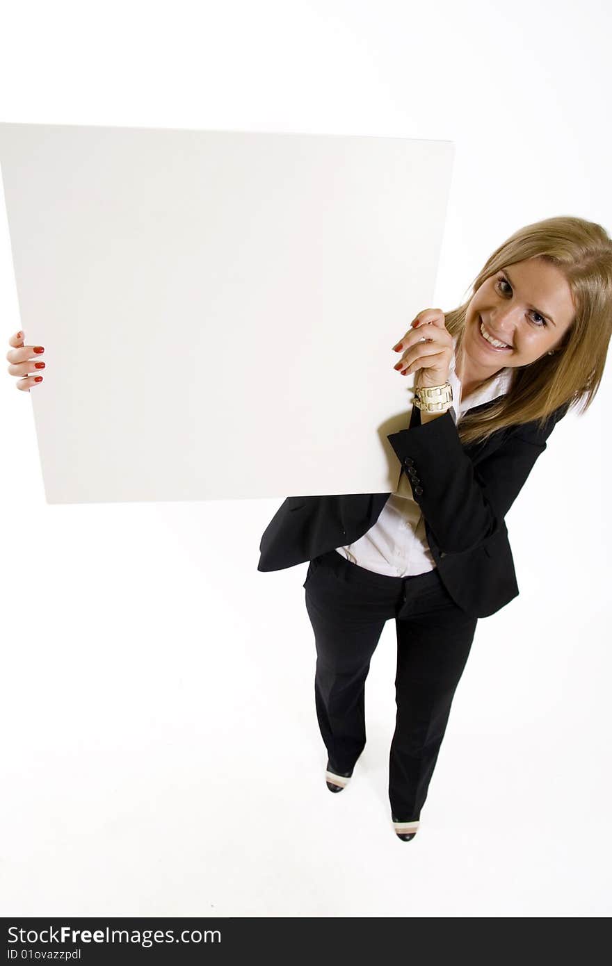 Wide angle picture of an attractive businesswoman presenting a blank board