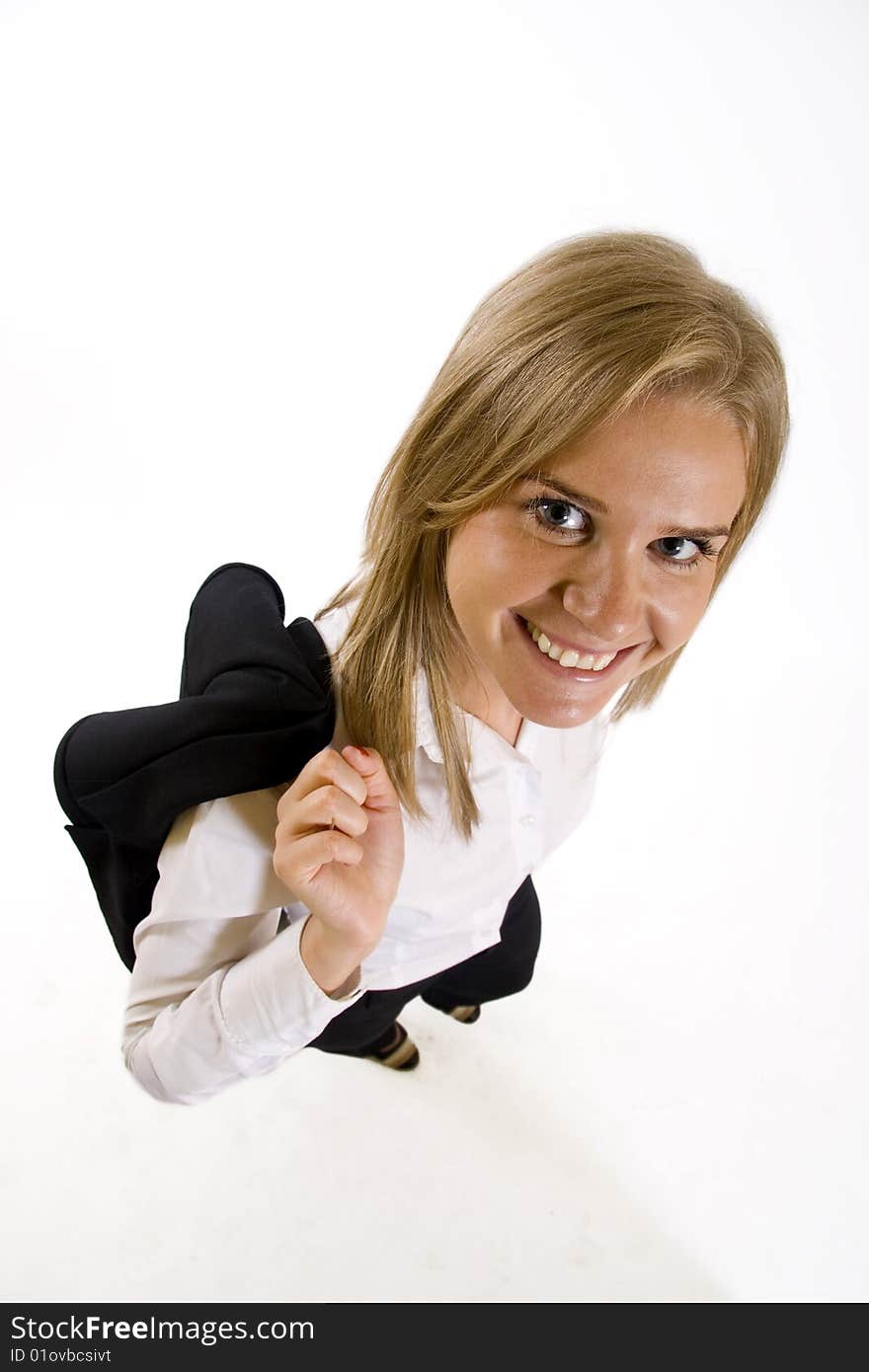 Wide angle picture of an attractive businesswoman with coat on her back