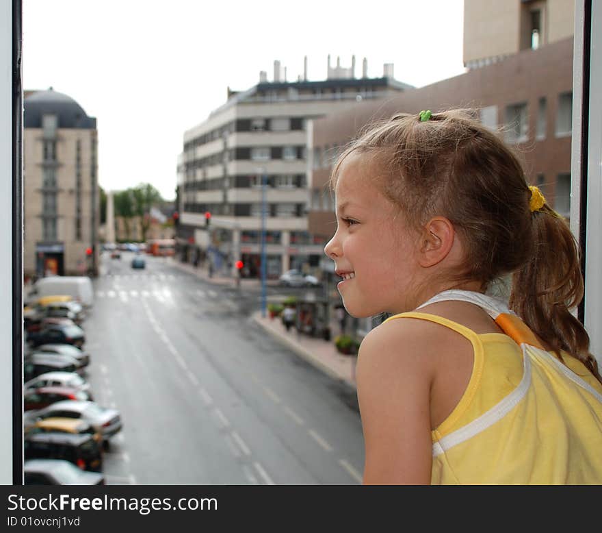 Little girl at open window