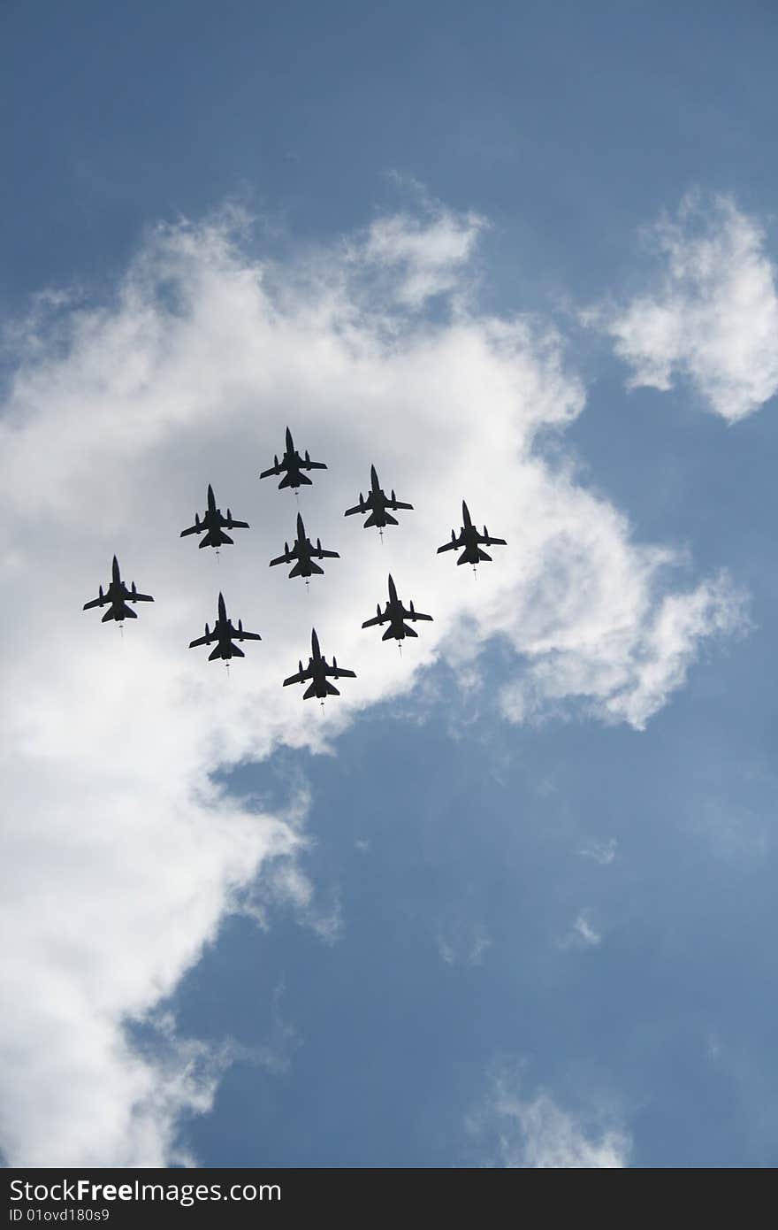 A jet formation silhouetted against the clouds, taken in London