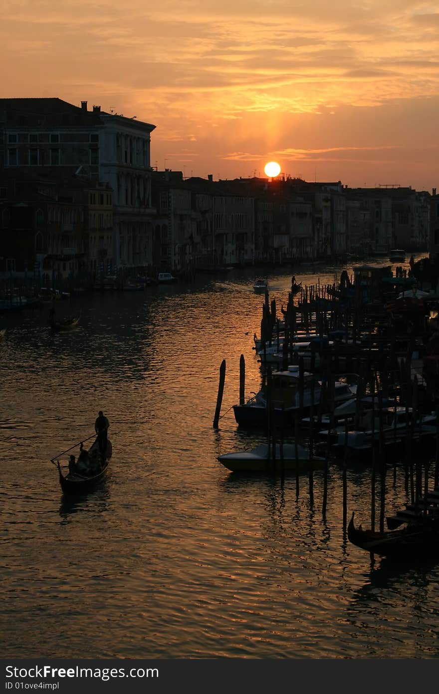 Silhouetted gondolier at sunset on the Grand Canal in Venice