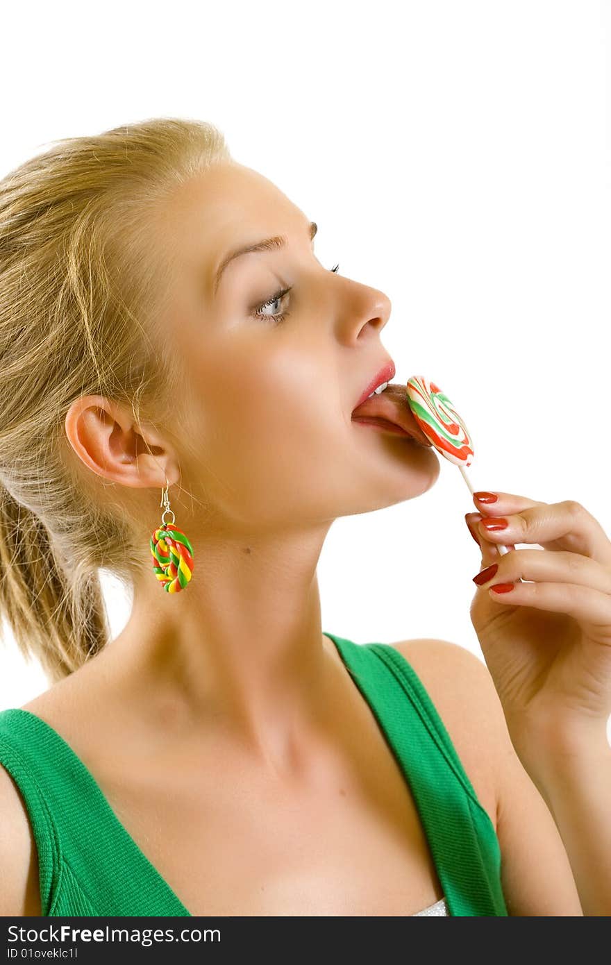 Closeup of an attractive woman liking a lolly pop