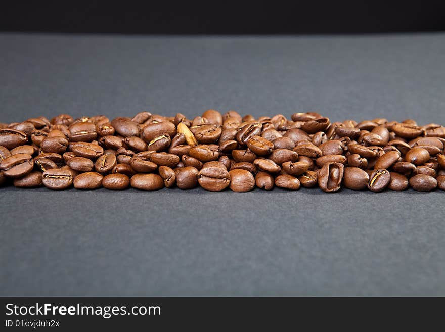 Strip from coffee beans against a dark background