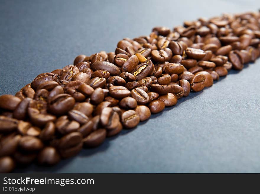 Strip from coffee beans against a dark background. Strip from coffee beans against a dark background