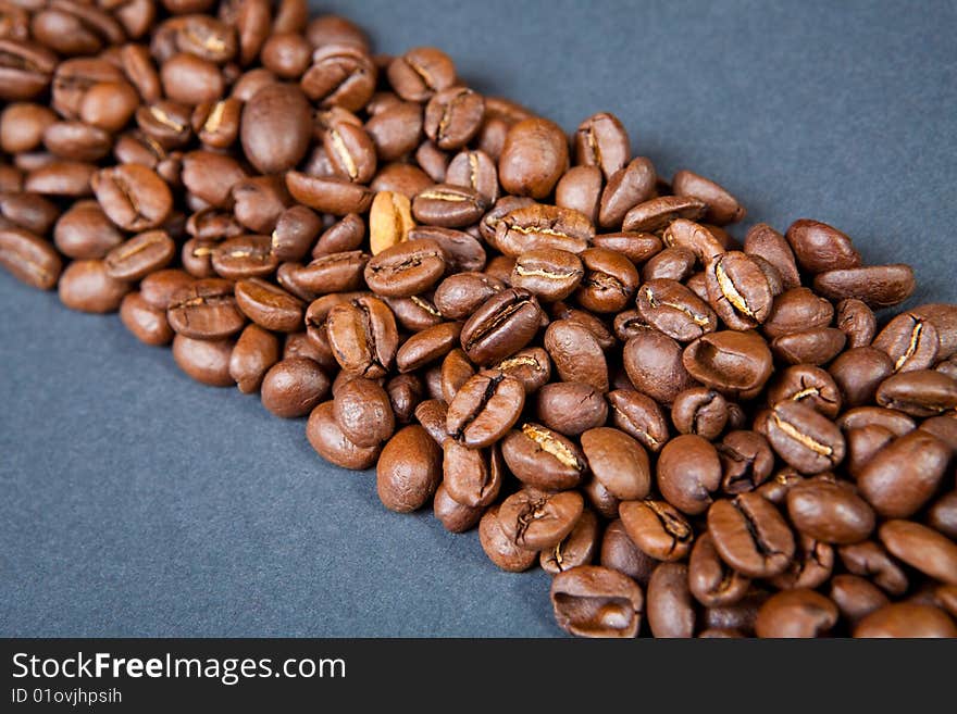 Strip from coffee beans against a dark background. Strip from coffee beans against a dark background