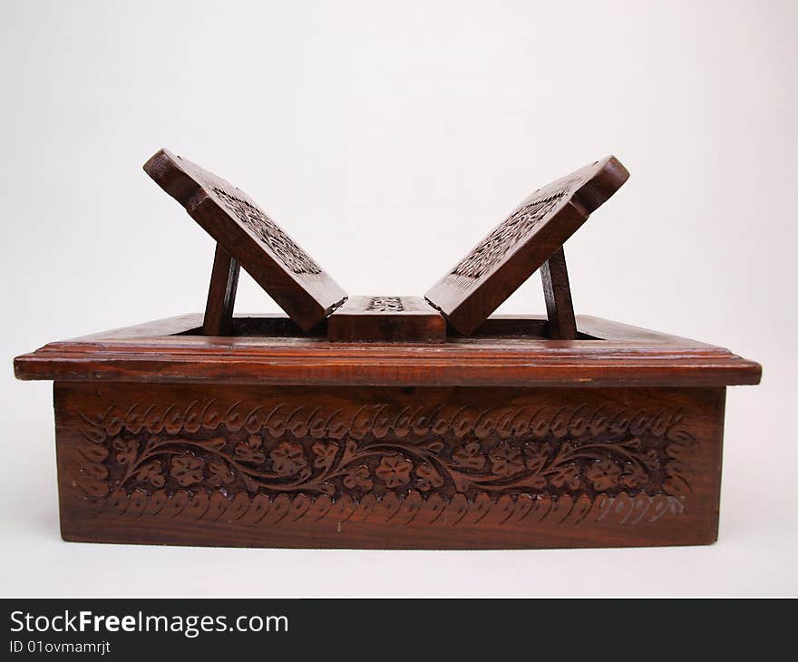 Front perspective view of decorative floral pattern brown colored wooden chest box for storing items like books, jewelry, & other small items. Front perspective view of decorative floral pattern brown colored wooden chest box for storing items like books, jewelry, & other small items.