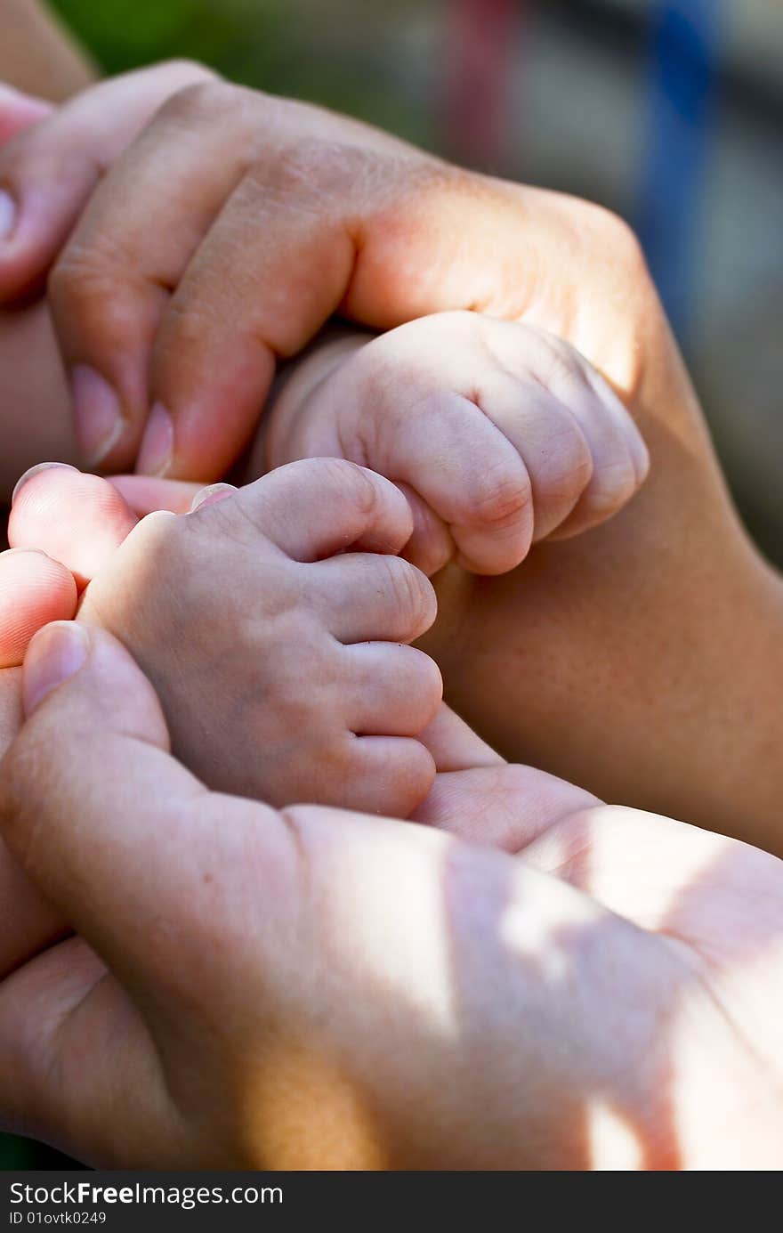 Close capture on women holding baby hand. Close capture on women holding baby hand