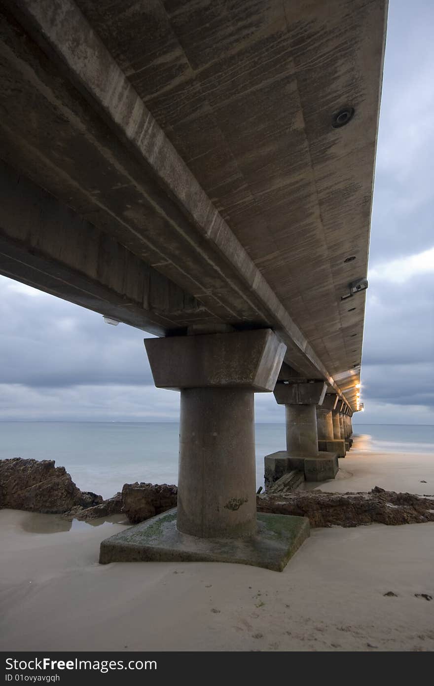 A photograph of a pier in Port Elizabeth, South Africa before sunrise. A photograph of a pier in Port Elizabeth, South Africa before sunrise.