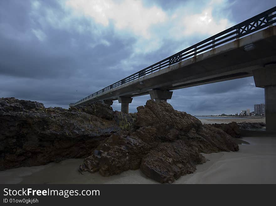 A photograph of a pier in Port Elizabeth, South Africa before sunrise. A photograph of a pier in Port Elizabeth, South Africa before sunrise.