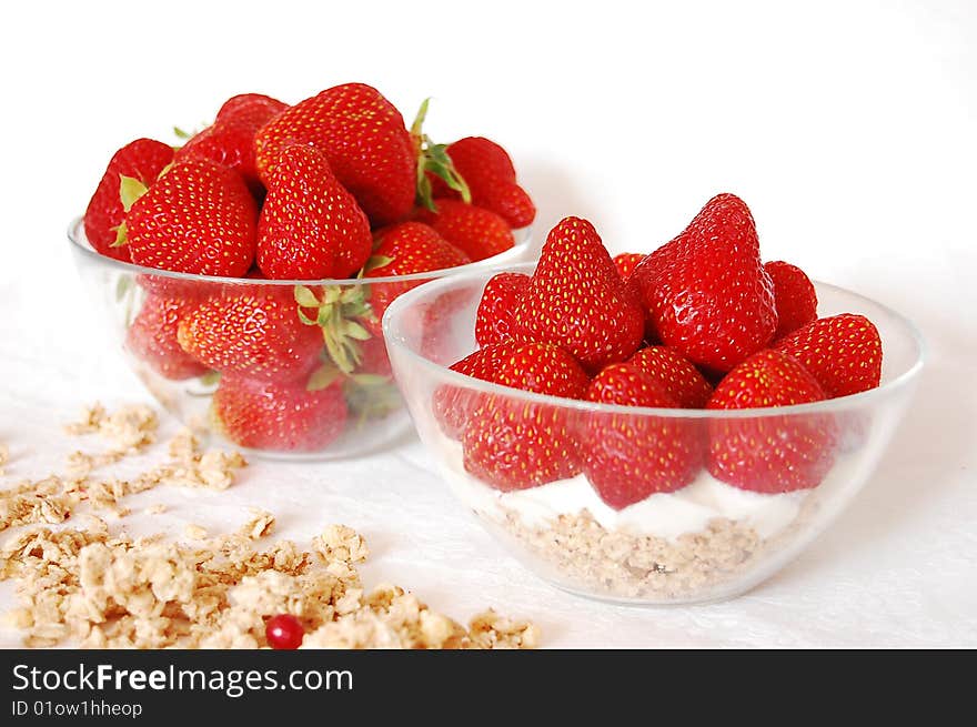 Strawberries, youghurt and muessli on a white table. Strawberries, youghurt and muessli on a white table