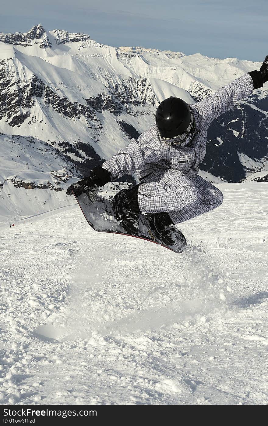 Snowboarder flying over the slope