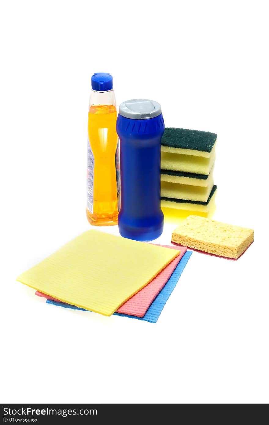 Cleaning supplies on white background including several spray bottles of chemicals,  sponges