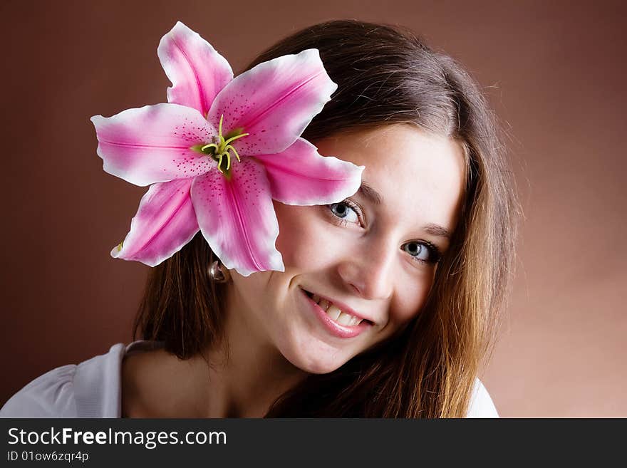 Young Woman Posing With A Pink Lily