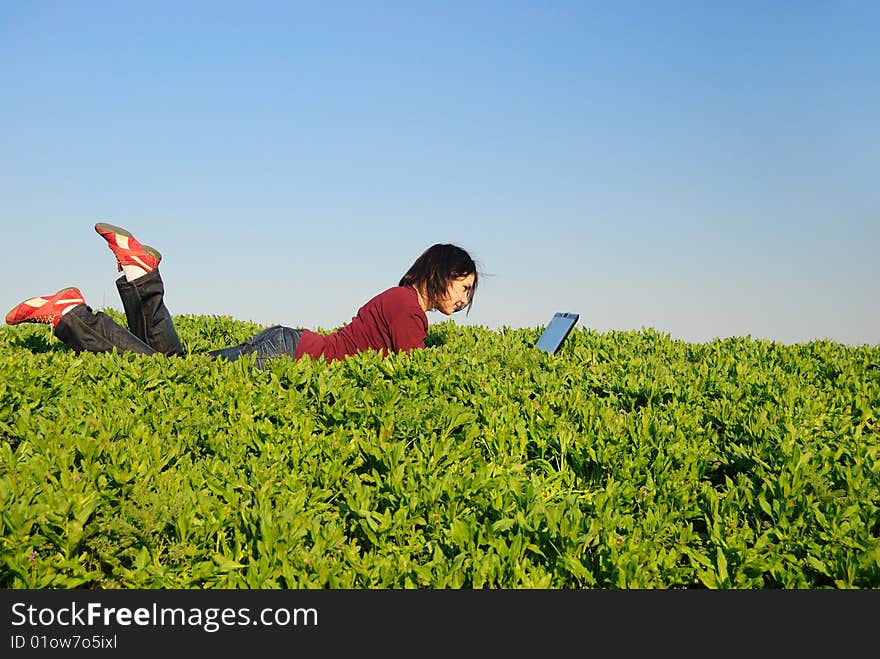 The beautiful girl with the laptop in the field. The beautiful girl with the laptop in the field