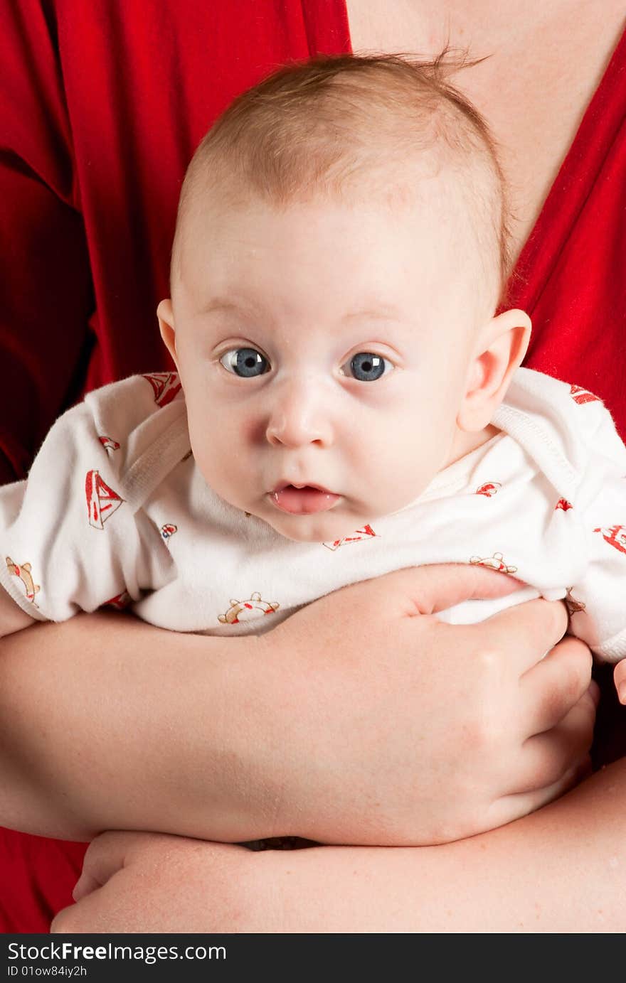 Beauty baby boy with blue eyes on claret red background.