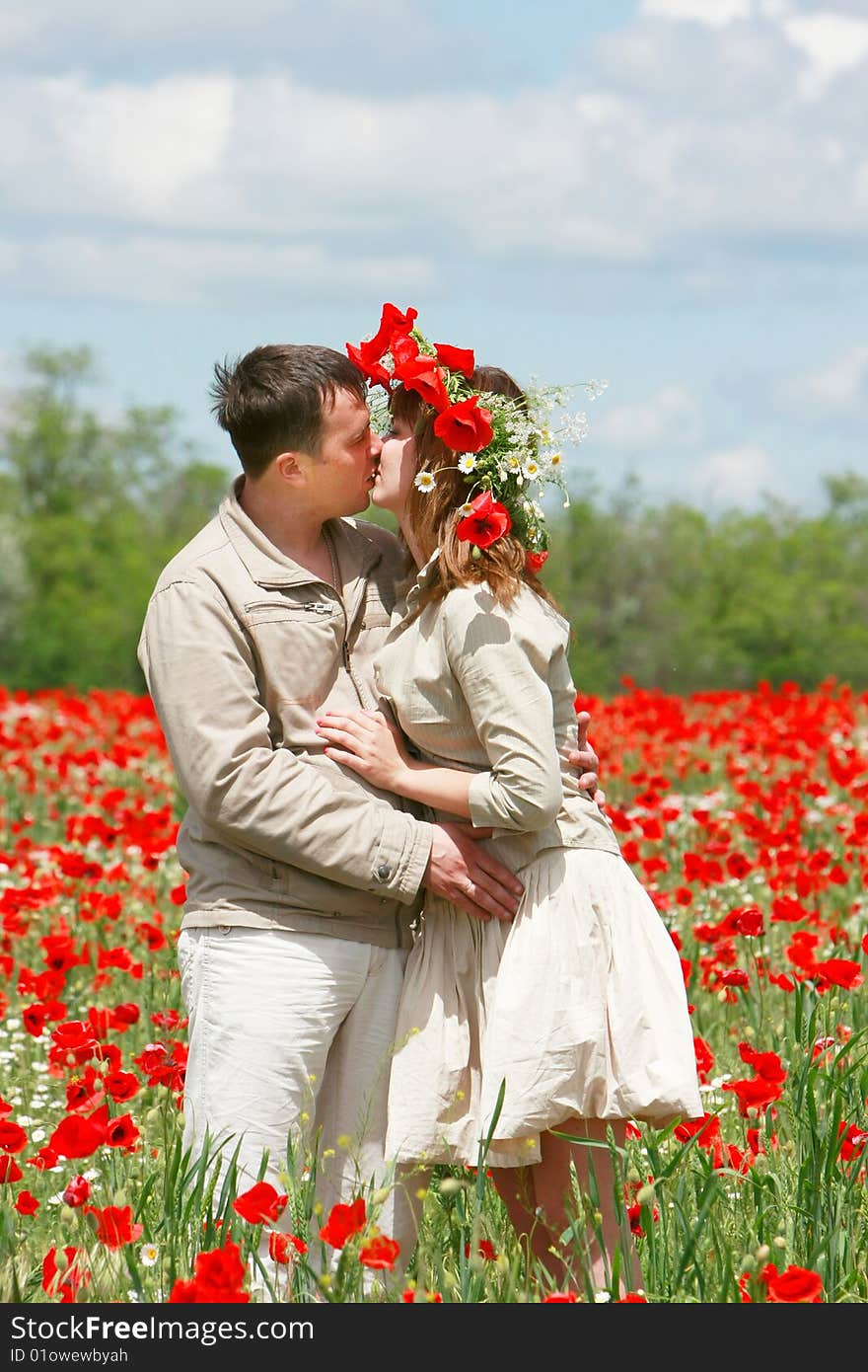 Couple On Red Poppies Field