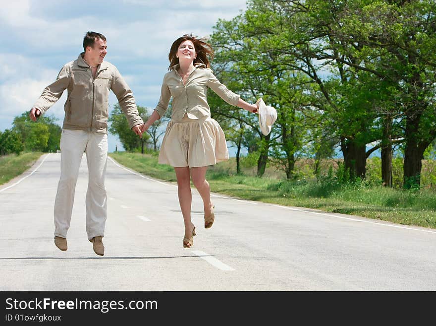 Couple jumping on rural road