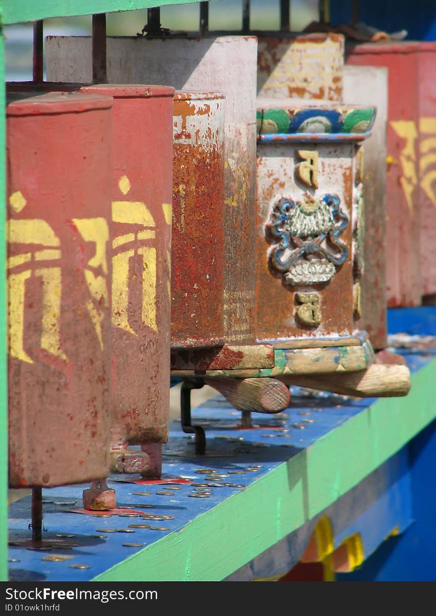 A red prayer wheels in buddhist university monastery.