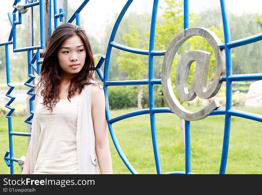 A modern Asian girl is before the modern network model outdoors. A modern Asian girl is before the modern network model outdoors.