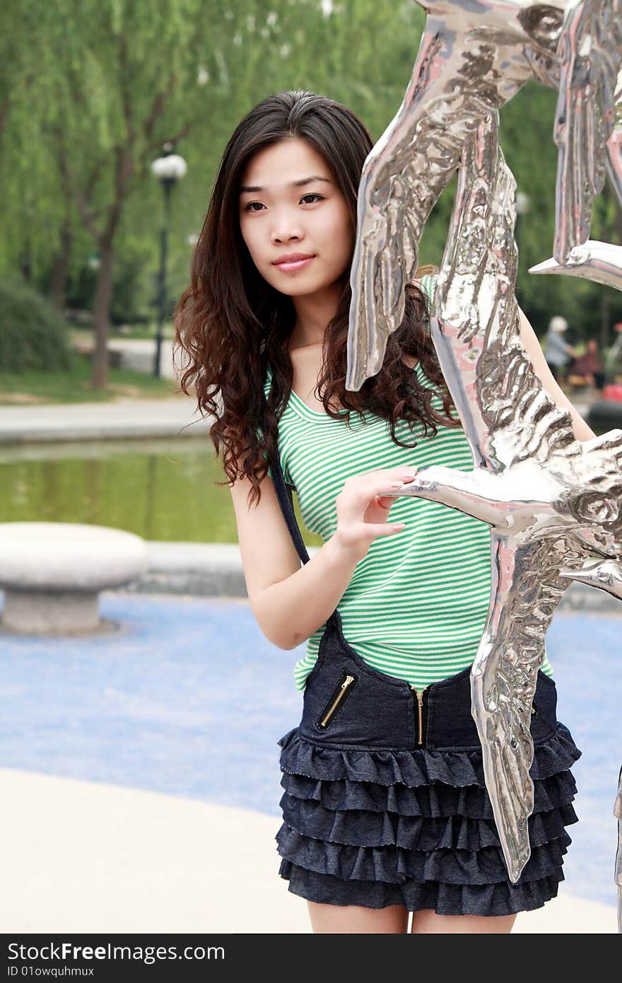 A beautiful Asian girl is in the portrait outdoors. A beautiful Asian girl is in the portrait outdoors.