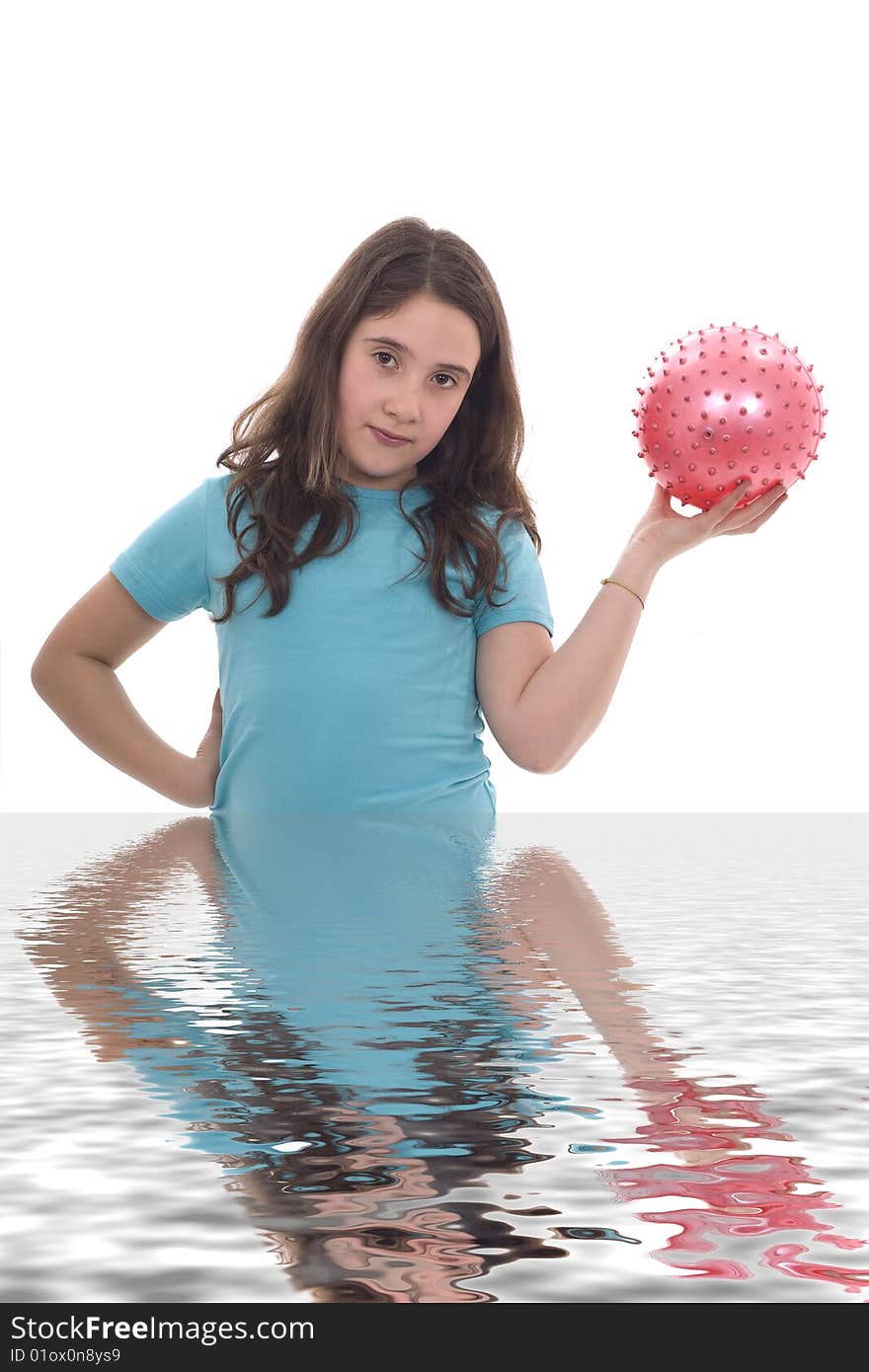 A young girl holding a pink ball and her own reflection. A young girl holding a pink ball and her own reflection