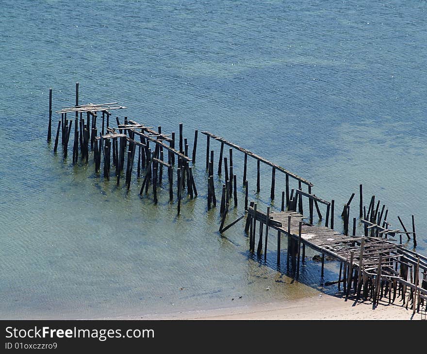 Collapsing Pier on shallow waters taken in Provincetown, MA on Cape Cod. Collapsing Pier on shallow waters taken in Provincetown, MA on Cape Cod