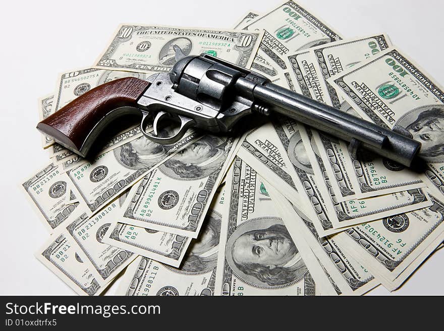 American dollar banknotes on isolated background and army Colt 45. American dollar banknotes on isolated background and army Colt 45