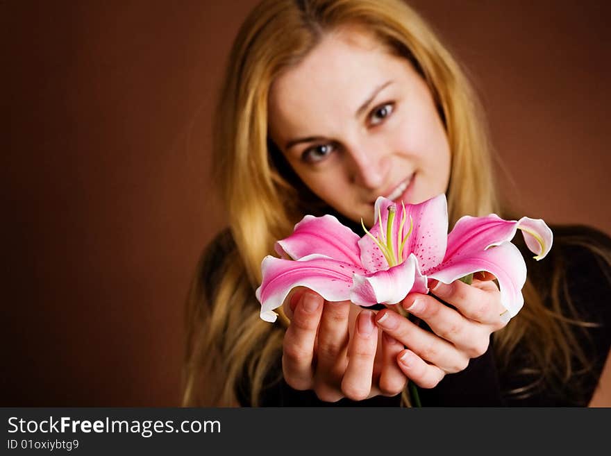 Young blonde with a pink lily