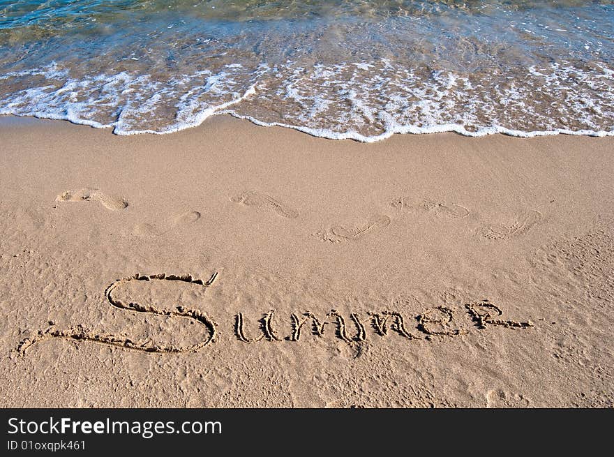 Inscription on sea sand near the sea