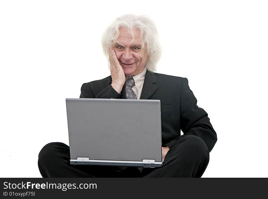 Older business man smiling and typing on laptop. Older business man smiling and typing on laptop