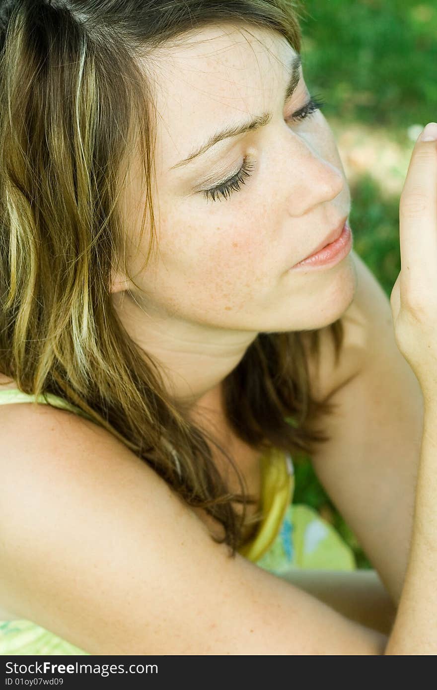 Beautiful woman sitting in meadow. Beautiful woman sitting in meadow