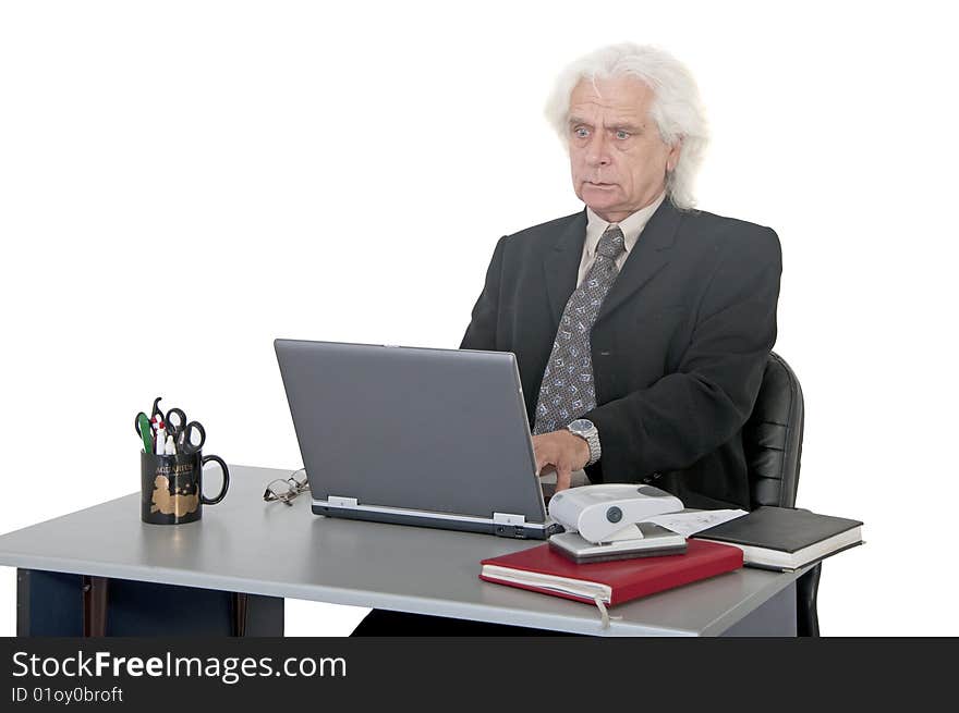 Older man worried typing on laptop