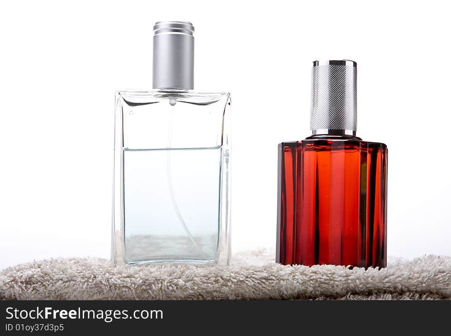 Two perfume bottles on a towel. Two perfume bottles on a towel