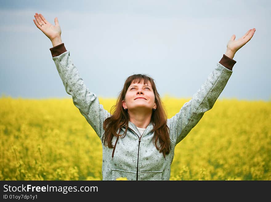 Happy girl with fluttering hair in flower field. Happy girl with fluttering hair in flower field