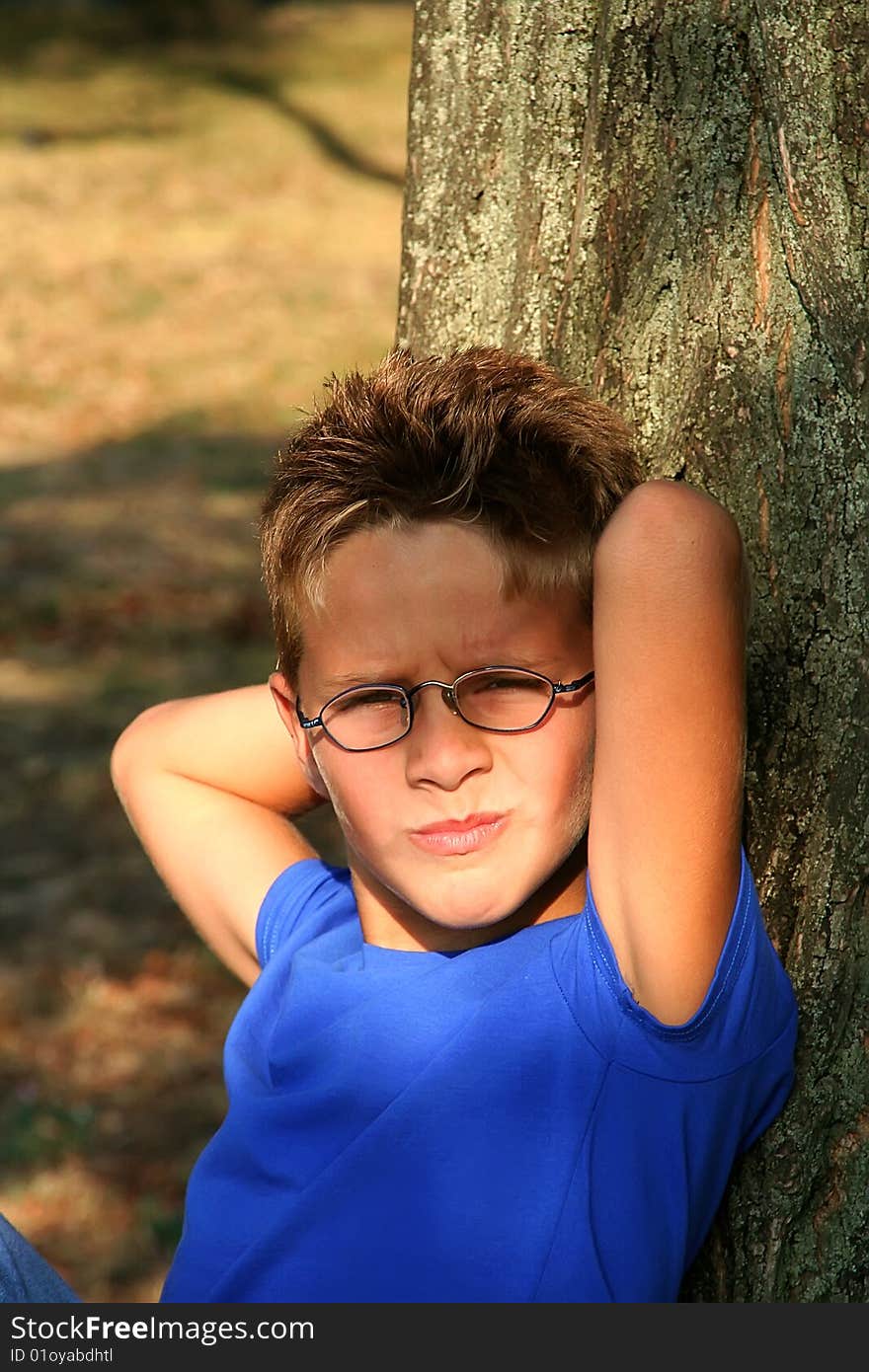 Boy by the tree in the forest