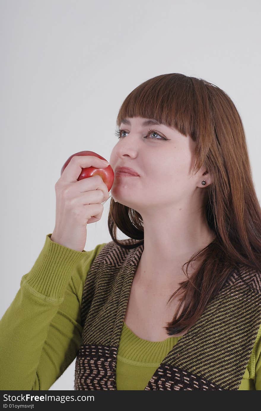 A girl is about to bite an apple. A girl is about to bite an apple