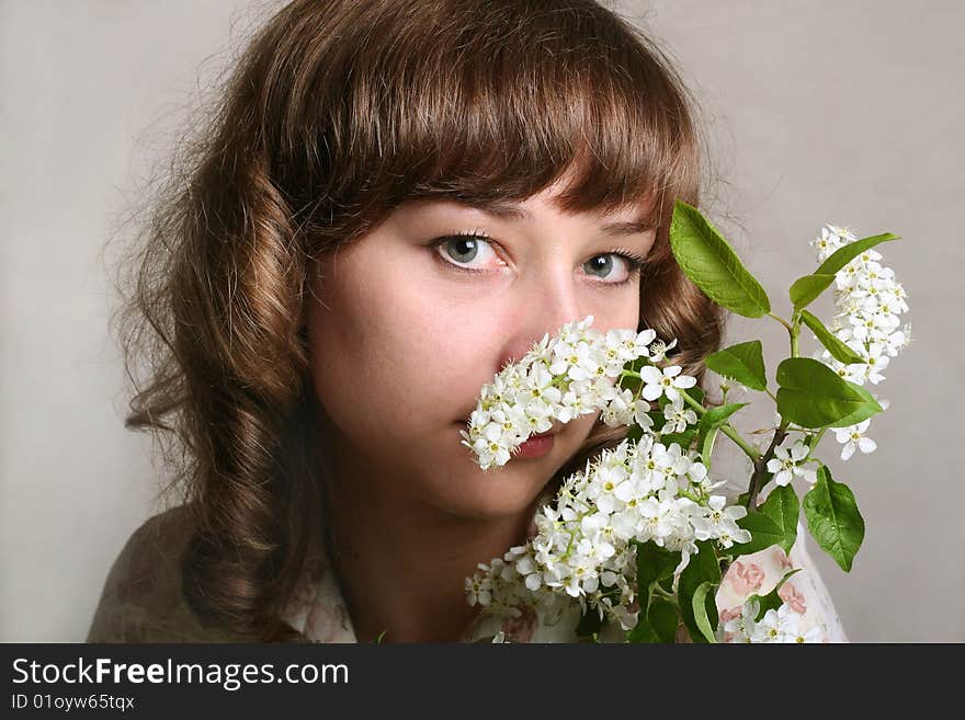 Girl with branch of bird cherry