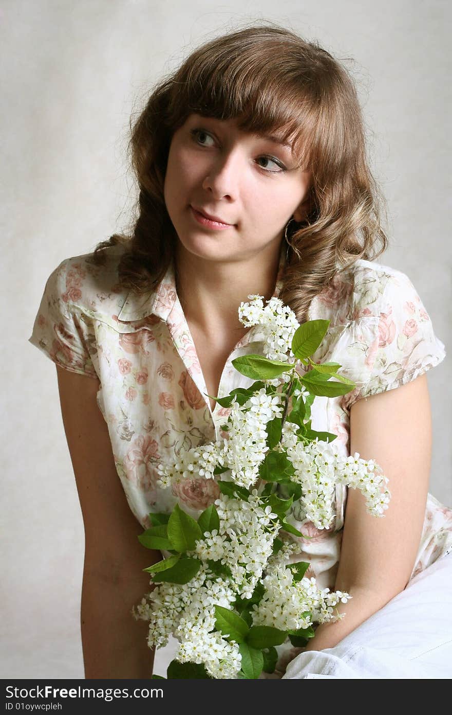 Portrait girl with branch of bird cherry