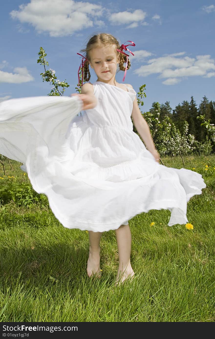 Little girl with white dress dancing