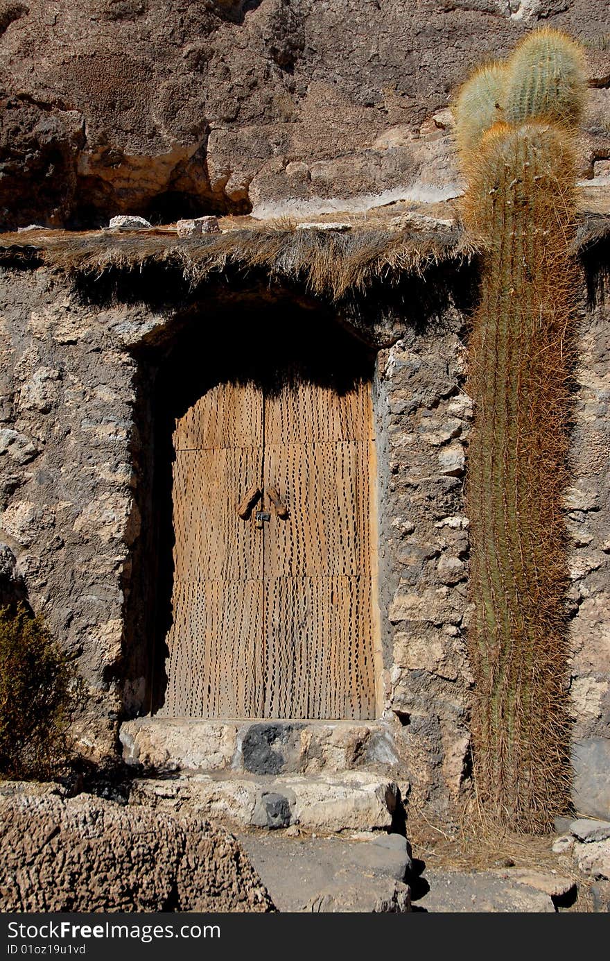 Bolivia, door of a house built in the rock