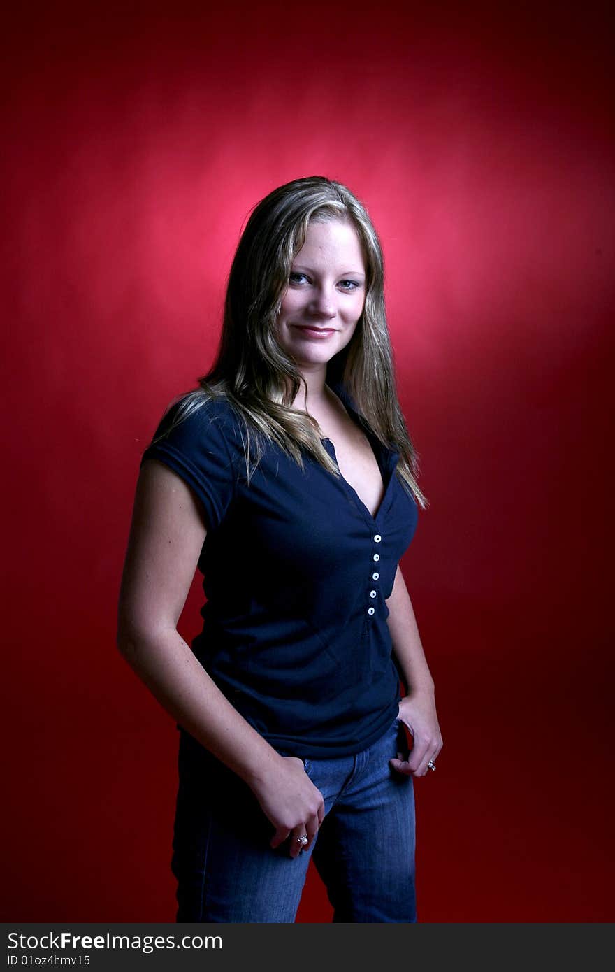 Pretty smiling young woman against red background